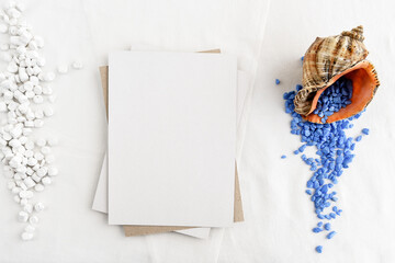 Fashionable stock stationery background - white map and seashells on a white table. Romantic background. Blank for an invitation card.