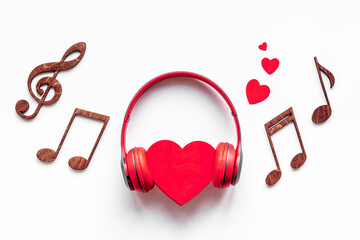 Red headphones with heart shape. Listen to the music concept