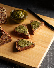 Side view on sliced triangle flourless diet grain bread on parchment paper