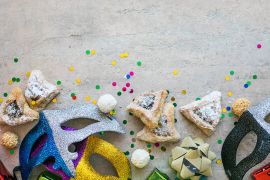 Purim celebration concept (jewish carnival holiday) on white background, top view, copy space. flat lay with hamantaschen cookies and purim mask.