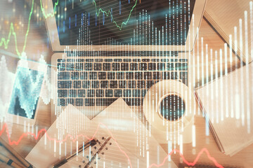 Stock market chart and top view computer on the table background. Double exposure. Concept of financial analysis.