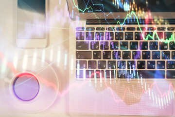 Stock market chart and top view computer on the table background. Multi exposure. Concept of financial analysis.