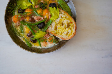 Delicious homemade quail egg omelette with tuna and olives. Served with toasts. 