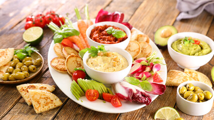 variety of fresh vegetables and dips