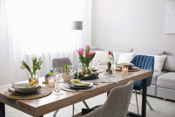 Beautiful Easter table setting with beautiful flowers in living room