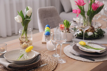 Beautiful Easter table setting with beautiful flowers indoors