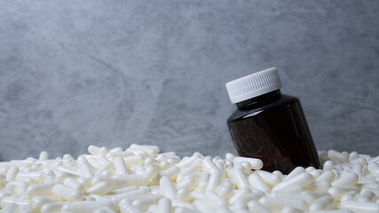 The Medicine bottle  and white capsules image  for  sci or medical content.
