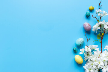 Happy Easter with eggs and flowering branch, top view