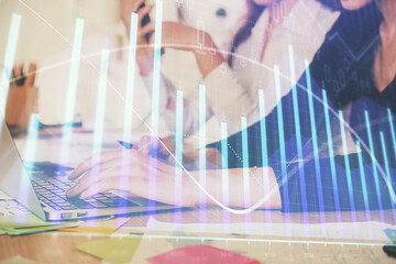 Multi exposure of woman hands typing on computer and financial graph hologram drawing. Stock market analysis concept.