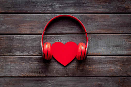 Listen to your heart. Headphones with heart of wooden, top view