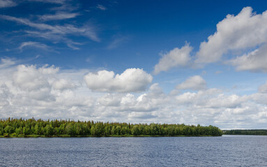 Lake Finland blue sky white clouds coniferous forest landscape