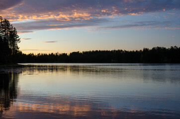 Fototapeta na wymiar Lake near Juuma Finland blue sky white clouds coniferous forest landscape