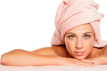 a young beautiful woman with blue eyes posing with a towel on her head