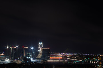 Fototapeta na wymiar Panoramic night view on Belgrade, (Beograd in Serbian), on river Danube and Sava and bridges over them, view at old but also new part of town