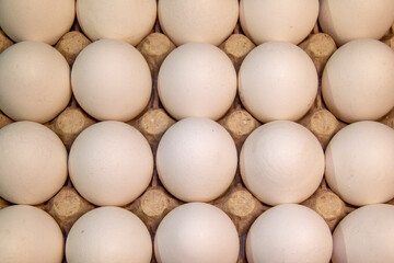Full package of chicken eggs. Large white chicken eggs in cardboard packaging