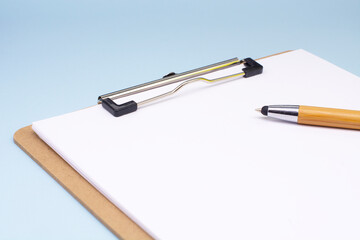 paper with a pen on a blue background. The concept of the transience of time. Business concept