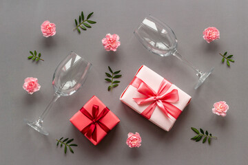 Valentines Day pattern of pink gift box and flowers. Overhead view