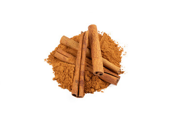 Powdered cinnamon and cinnamon sticks on a white background
