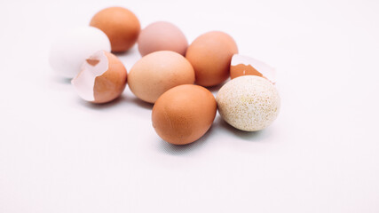 Brown and white chicken eggs on white background