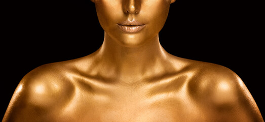 Fashion Gold Skin Beauty Woman Portrait. Face Model Golden Makeup. Gold Lips Make up and Shiny Body Paint over Black