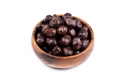 Black olives in wooden bowl on white background