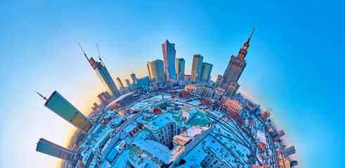 Beautiful panoramic aerial drone view on Warsaw City Skyscrapers, PKiN, and Varso Tower under construction and 19th-century tenement houses during the January sunset, Warsaw, Poland.