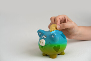 Piggy bank, hand holds golden bitcoin coin virtual money.