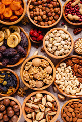 Various Nuts and dried fruits in wooden bowls.