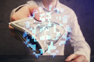 Double exposure of technology drawing hologram and us dollars bills and man hands. Data concept