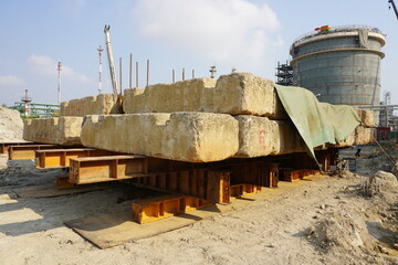 Cement blocks to press down on the pile as part of Dynamic load test in the area of chemical plant construction.