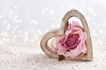 love background with wooden heart and pink rose