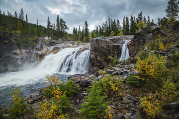 Hyttfossen waterfall in autumnal scenery