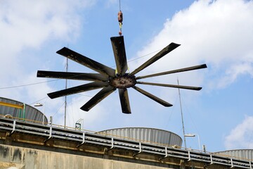 Fan blades of cooling tower is being lifted down for waiting for maintenance in chemical plant.