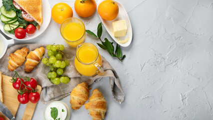 Delicious fresh breakfast served with drinks, croissants and fruits.