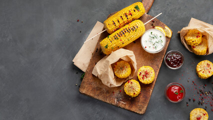 Grilled roasted sweet corn cobs with souces