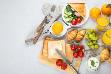 Delicious fresh breakfast served with drinks, croissants and fruits.