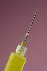 injection syringe with needle detail on colored background