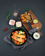 Homemade fresh salmon with starter and vegetables on dark background