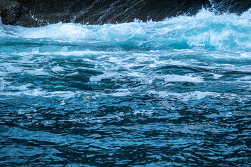 beautiful, blue sea with big, high waves, foam in a storm in the evening