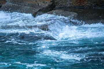 beautiful, blue sea with big, high waves, foam in a storm in the evening