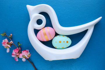 Easter card design. figurine of a white bird, multi-colored Easter eggs and flowers. congratulation