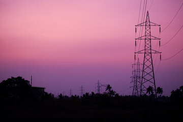 Silhouette of transmission towers in the countryside at