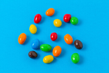 Colorful glazed candies on a blue background
