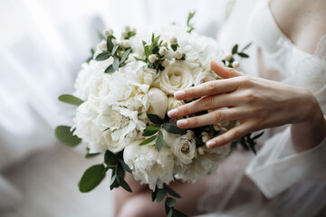 Bridal morning details. Wedding bouquet in the hands of the bride.