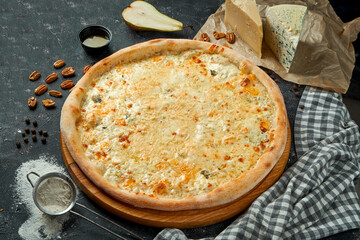 Appetizing Italian pizza 4 cheese on a composition with ingredients on a black background