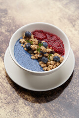 Breakfast smoothie bowl with granola table