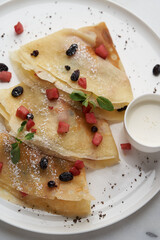 Crepes, apple pancake or caramelized apple crepe with yoghurt cream