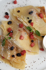 Crepes, apple pancake or caramelized apple crepe with yoghurt cream