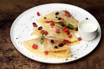 Crepes, apple pancake or caramelized apple crepe with yoghurt cream