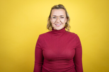 Obraz premium Young caucasian woman wearing casual red t-shirt over yellow background with a happy face standing and smiling with a confident smile showing teeth